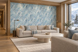 Alpine lounge with blue-gray abstract wallpaper, oak joinery, oatmeal sofas and a pale stone coffee table beside a snowy mountain window.