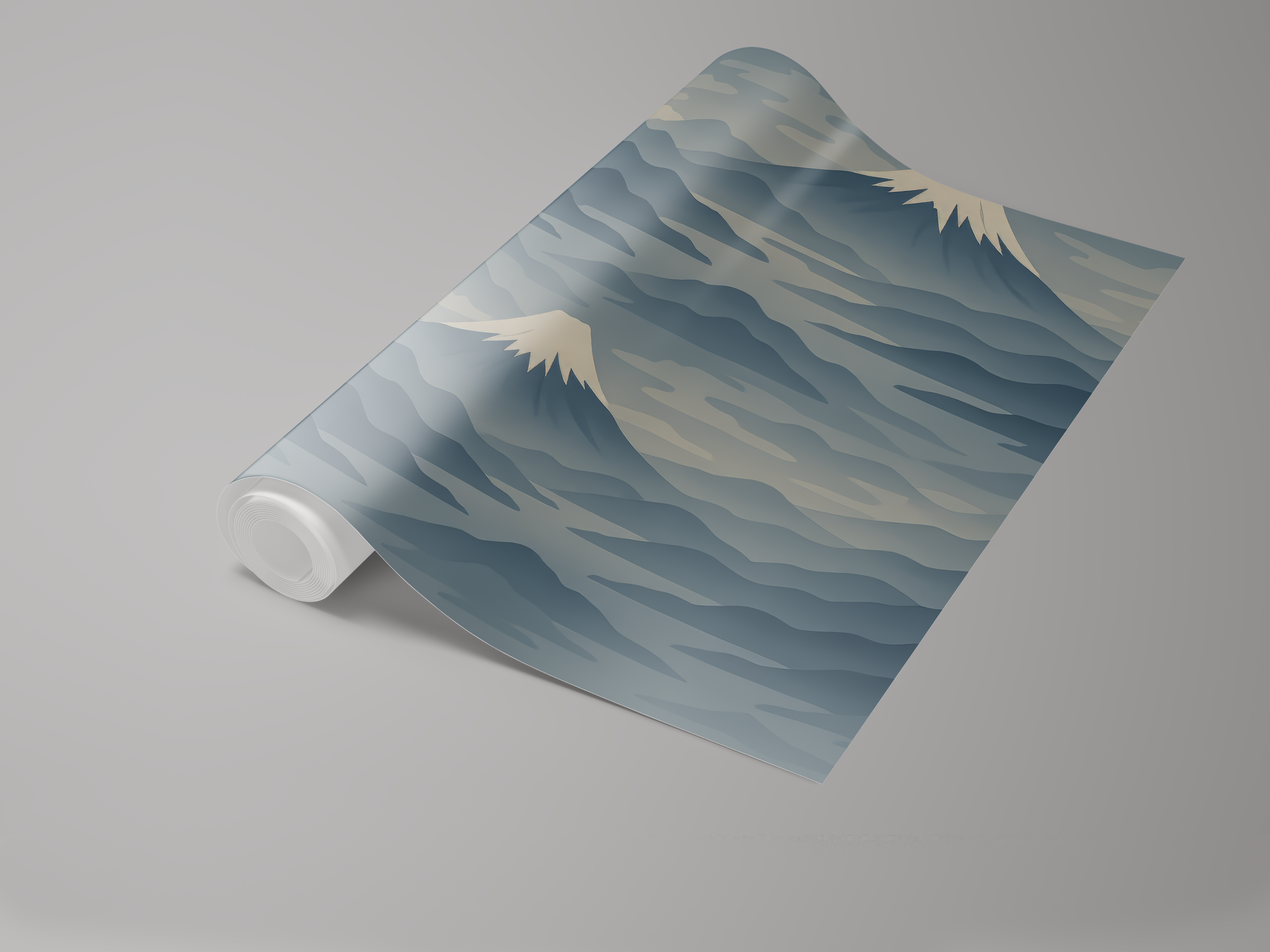 Mountain themed wallpaper in muted blues with snowcapped peaks, from Brewster Home Fashions, shown rolled on a gray background.