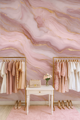 Rose quartz luxe wallpaper with gold accents, showing a wavy marble-like pattern in shades of pink and gold.