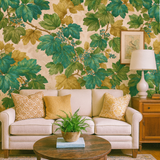 Botanical wallpaper with green and gold leaves, patterned across a cream colored background.
