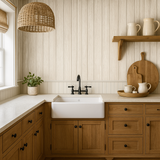 Whitewashed planks wallpaper with vertical wood grain paneling, covering the wall in a kitchen.
