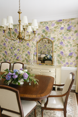 Floral wallpaper with vines and purple flowers, featuring a delicate painted pattern.