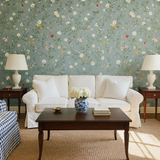 Floral print Strawberry Thicket Wallpaper with daisies and vines on a light blue background.
