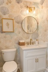Low Tide Relics Wallpaper with shell and starfish pattern over a light beige backdrop.