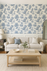 Toile Harmonie Wallpaper with blue pastoral print on cream background featuring white trim and decor.