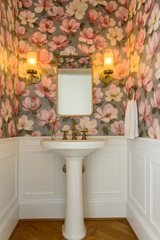 Magnolia Reverie wallpaper with pink flowers and grey background, creating a vintage, floral-themed bathroom interior.
