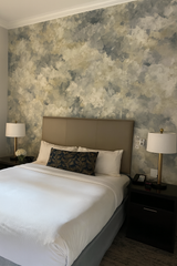 Cloud-patterned wallpaper with blue and beige hues, textured with an artistic, brushed effect.