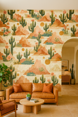 Painted Mesa Wallpaper with cactus and desert design, presented on a living room wall.
