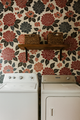Floral bloom wallpaper with red and navy print against a light neutral background.