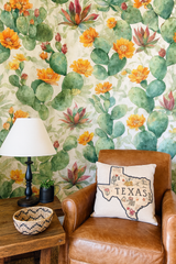 Prickly pear paintings wallpaper with orange flower and cactus details on a light neutral background.
