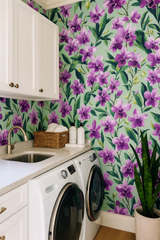Velvet Tropica Wallpaper with a purple orchid floral design over light green backdrop.