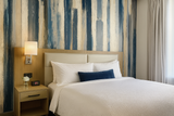 Gouache Drift wallpaper with painted stripes in blue and beige tones.