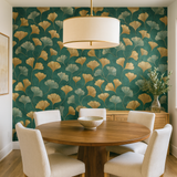 Gilded ginkgo wallpaper with gold and gray leaf pattern, by Wallshoppe, decorates a dining room.
