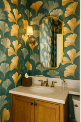 Gilded ginkgo wallpaper in gold and gray with leaf pattern on a teal textured background.
