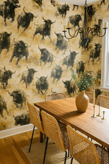 La Matador wallpaper with running bulls pattern on a golden background.