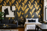 Golden Tropic Wallpaper with gold banana leaf pattern on black background.
