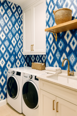 Indigo Mirage wallpaper with a blue and white ikat pattern, decorating a laundry room.