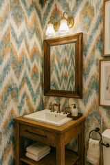 Zigzag Zuni Wallpaper with blue and orange patterns, adorning a textured wall in a bathroom setting.
