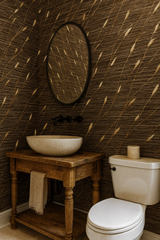 Wheat Whiskers Wallpaper with a brown and gold pattern, covering a bathroom wall with a round mirror.
