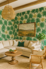 Palm Parade Wallpaper with a green palm frond pattern and a creamy beige background.
