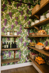 Vineyard Whimsy Wallpaper featuring a repeating pattern of grapes and leaves on a light background.
