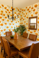 Poppy Parade in Citrus Bloom Wallpaper with orange floral design on a white background.