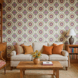 Patterned wallpaper by Stitch & Rosette featuring purple, orange, and green floral medallions on a textured background.
