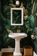 Jungle Tones wallpaper with green leaves pattern, covering the bathroom walls.