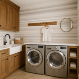 Feather fade stripes wallpaper with horizontal stripe pattern, above laundry machines and cabinets.