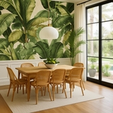 Botanical Havana Canopy wallpaper with green foliage against a beige background, styled in a dining room.