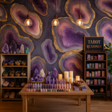 Violet geode wallpaper featuring gold accents, with crystals and tarot cards on display.
