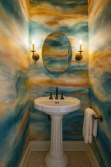 Dune Mirage wallpaper with an abstract cloud pattern, featuring a golden oval mirror above a pedestal sink.