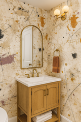 Studio Spatter wallpaper with black, gold, and purple spatter patterns on a beige background.