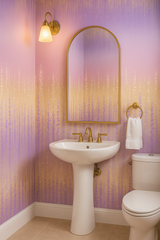 Lavenderfall wallpaper with a lavender and gold waterfall pattern, covering the bathroom walls.