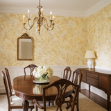 Golden damask wallpaper featuring leaf patterns and a floral texture.
