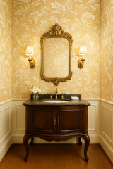 Golden damask wallpaper with a leafy pattern in a traditional bathroom setting.
