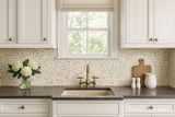 Pebblefield wallpaper with beige pebble pattern on white background, visible behind kitchen sink and decor.
