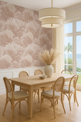 Blush coral forest wallpaper with tree pattern, against white wainscoting and window.