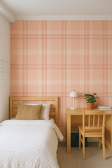 Blush plaid wallpaper with a square pattern, covering an entire wall in a bedroom scene.
