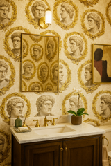 Laurel Imperium Wallpaper with bust pattern, floral wreaths, and gold accents.