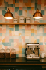 Palm Springs Mosaic Wallpaper with colorful, geometric patterned design of squares, circles, and lines in pastel colors.