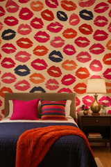 Velvet Kiss Wallpaper with multicolored lipstick pattern on a cream-colored background covering the wall in a bedroom setting.
