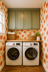 Floral Sun-Kissed Tithonia Wallpaper with orange daisy pattern covering the walls of a laundry room.