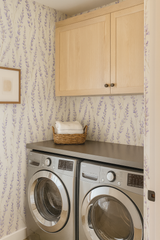 Lavender Reverie wallpaper with floral pattern on a laundry room wall.