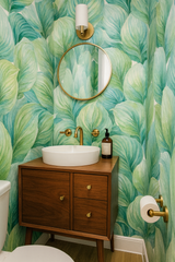 Hosta Hush wallpaper with green leaf pattern, covering an entire bathroom wall.
