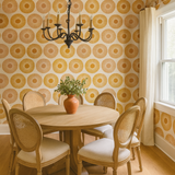 Yellow and orange patterned wallpaper with circular designs, featuring a vintage style.

