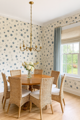 Floral confetti wallpaper with blue flower pattern on white textured backdrop.