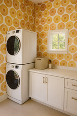 Yellow and white patterned wallpaper with a circle design and sunburst detail.