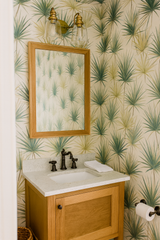 Yucca Mirage wallpaper with a palm leaf pattern, covering the bathroom walls in this shot.
