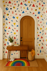 Mod Scatter Pop wallpaper with primary color geometric shapes, black squiggles, and confetti pattern, displayed on an interior wall.
